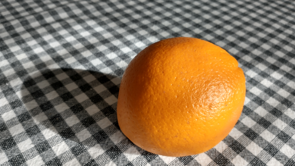 orange on a black-and-white checked tablecloth